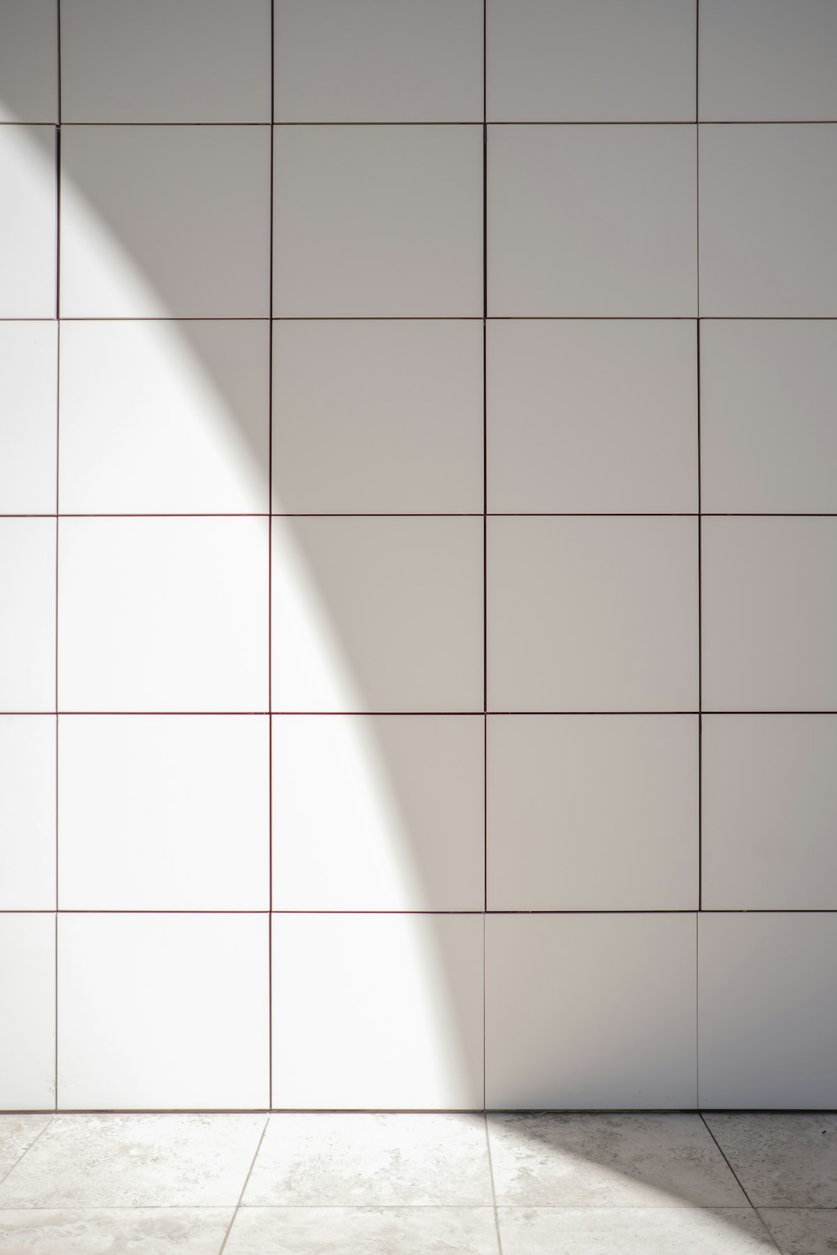 Close detail of white and grey ceramic tile surface texture.